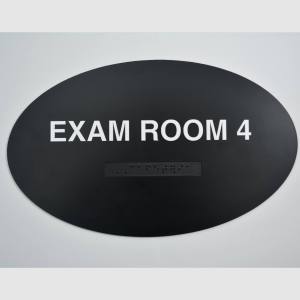 Exam Room 4 black oval braille sign